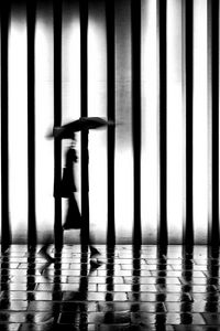 Preview wallpaper man, silhouette, rain, bw, lattice, movement