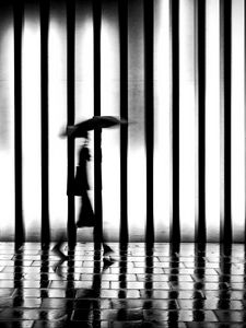 Preview wallpaper man, silhouette, rain, bw, lattice, movement