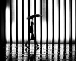 Preview wallpaper man, silhouette, rain, bw, lattice, movement