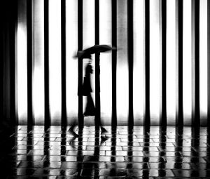 Preview wallpaper man, silhouette, rain, bw, lattice, movement