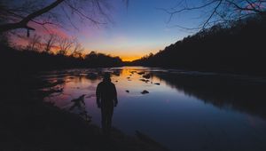 Preview wallpaper man, silhouette, river, trees, sky, solitude, harmony