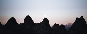 Preview wallpaper man, silhouette, rocks, outlines, dusk, dark