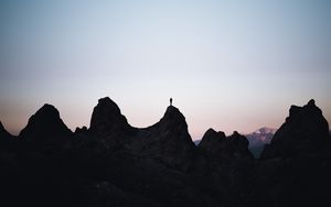 Preview wallpaper man, silhouette, rocks, outlines, dusk, dark