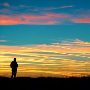 Preview wallpaper man, silhouette, sky, sunset, alone