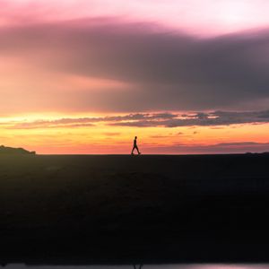 Preview wallpaper man, silhouette, sunset, horizon, reflection