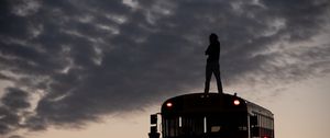 Preview wallpaper man, silhouette, triumph, alone, bus, sunset