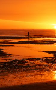 Preview wallpaper man, silhouette, water, horizon, sunset, alone