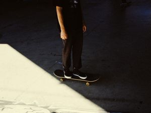 Preview wallpaper man, skateboard, legs, asphalt, shadow