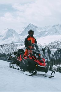 Preview wallpaper man, snowmobile, helmet, slope, snow