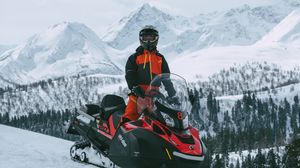 Preview wallpaper man, snowmobile, helmet, slope, snow