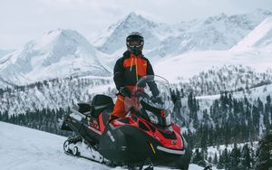 Preview wallpaper man, snowmobile, helmet, slope, snow