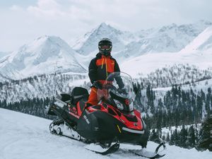 Preview wallpaper man, snowmobile, helmet, slope, snow