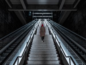 Preview wallpaper man, stairs, alone, sad, escalator, building, architecture