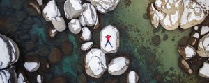 Preview wallpaper man, stones, rocks, snow, aerial view