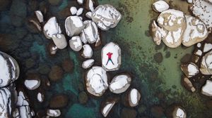 Preview wallpaper man, stones, rocks, snow, aerial view