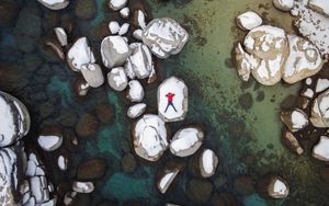 Preview wallpaper man, stones, rocks, snow, aerial view