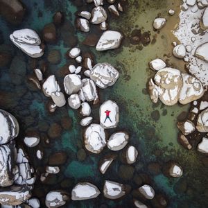 Preview wallpaper man, stones, rocks, snow, aerial view