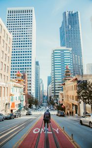 Preview wallpaper man, street, city, road, buildings, cars