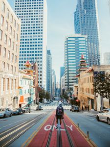 Preview wallpaper man, street, city, road, buildings, cars