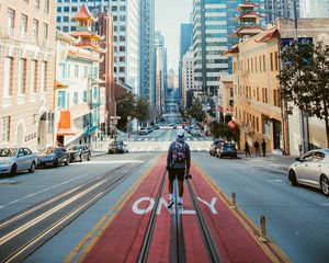 Preview wallpaper man, street, city, road, buildings, cars