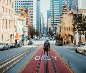Preview wallpaper man, street, city, road, buildings, cars