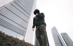 Preview wallpaper man, style, hood, bottom view, buildings