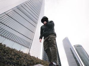 Preview wallpaper man, style, hood, bottom view, buildings