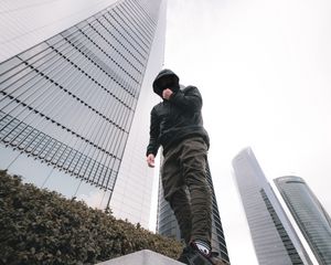 Preview wallpaper man, style, hood, bottom view, buildings