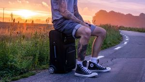 Preview wallpaper man, suitcase, sunset, tattoos