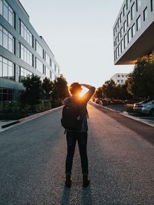Preview wallpaper man, sun, sunlight, street, city