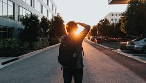 Preview wallpaper man, sun, sunlight, street, city