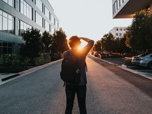 Preview wallpaper man, sun, sunlight, street, city
