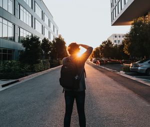 Preview wallpaper man, sun, sunlight, street, city