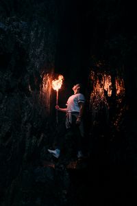 Preview wallpaper man, torch, cave, dark