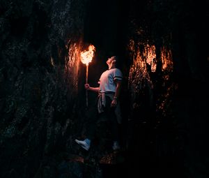 Preview wallpaper man, torch, cave, dark