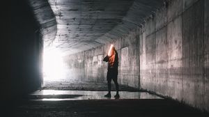 Preview wallpaper man, tunnel, lamp, glow, dark