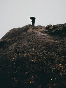 Preview wallpaper man, umbrella, alone, sad, silhouette, mountain, hill