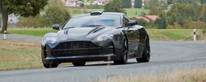Preview wallpaper mansory cyrus, 2009, black, front view, style, aston martin, houses, trees, asphalt