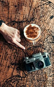 Preview wallpaper map, hand, cup, camera