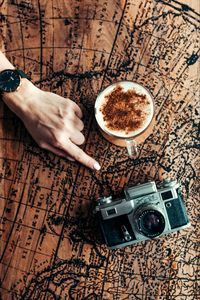 Preview wallpaper map, hand, cup, camera