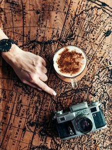 Preview wallpaper map, hand, cup, camera