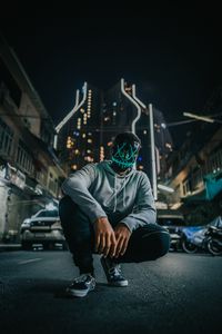 Preview wallpaper mask, man, anonymous, glow, city, street