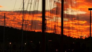 Preview wallpaper masts, silhouettes, trees, sky, evening