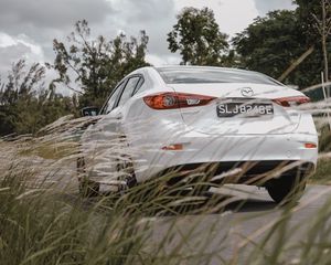 Preview wallpaper mazda 3, mazda, car, white, rear view, grass, trees