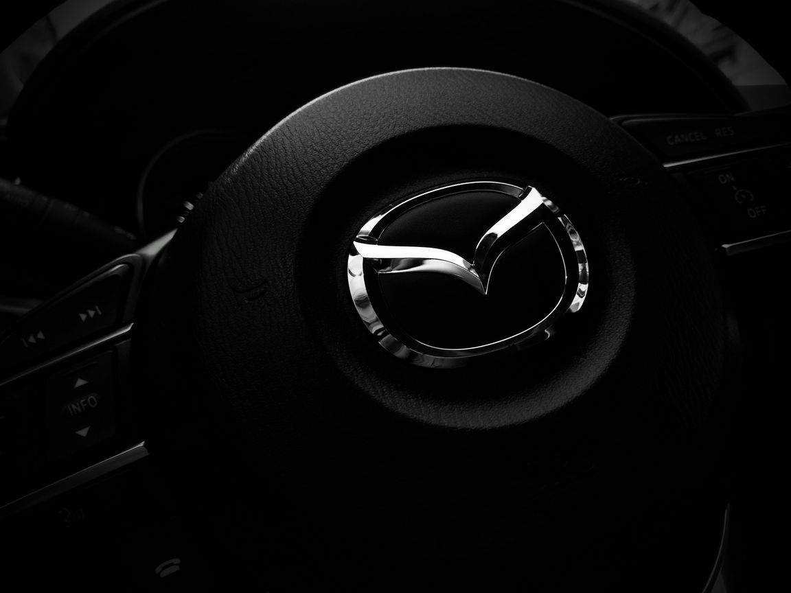 1152x864 Wallpaper mazda, steering wheel, logo
