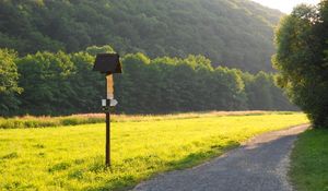 Preview wallpaper meadow, grass, road, sign, trees