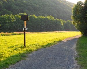 Preview wallpaper meadow, grass, road, sign, trees