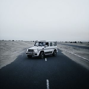 Preview wallpaper mercedes, car, suv, white, road, desert