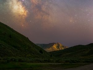 Preview wallpaper milky way, hills, grass, night