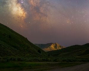 Preview wallpaper milky way, hills, grass, night